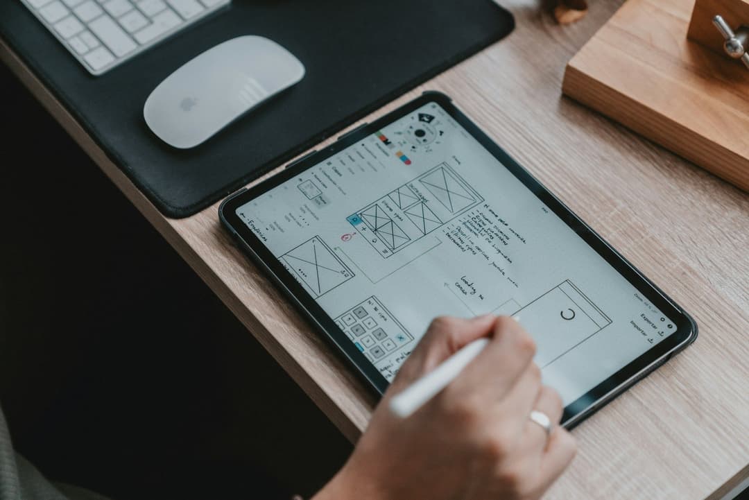person using ipad to design ui